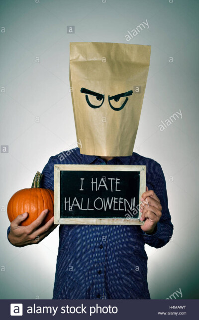 a young man with a paper bag in his head with a funny face holds a H4MAWT